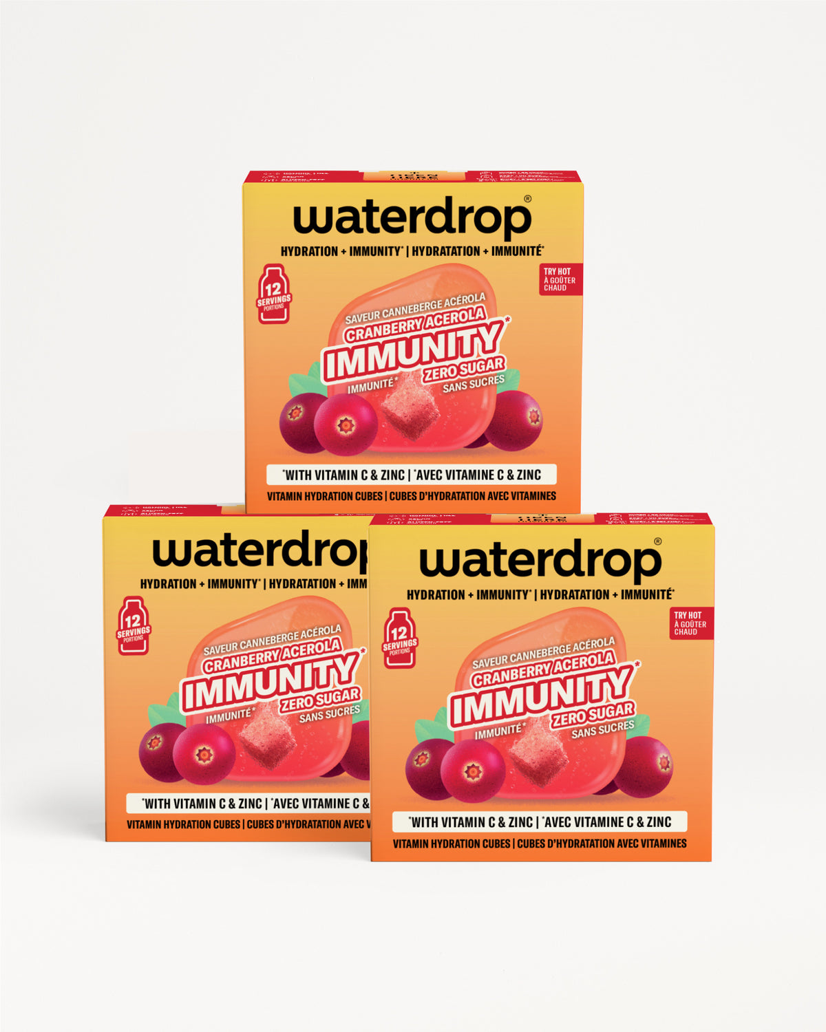 Tri narančasto-žute kutije Waterdrop imunosti složene zajedno s motivom bobica.